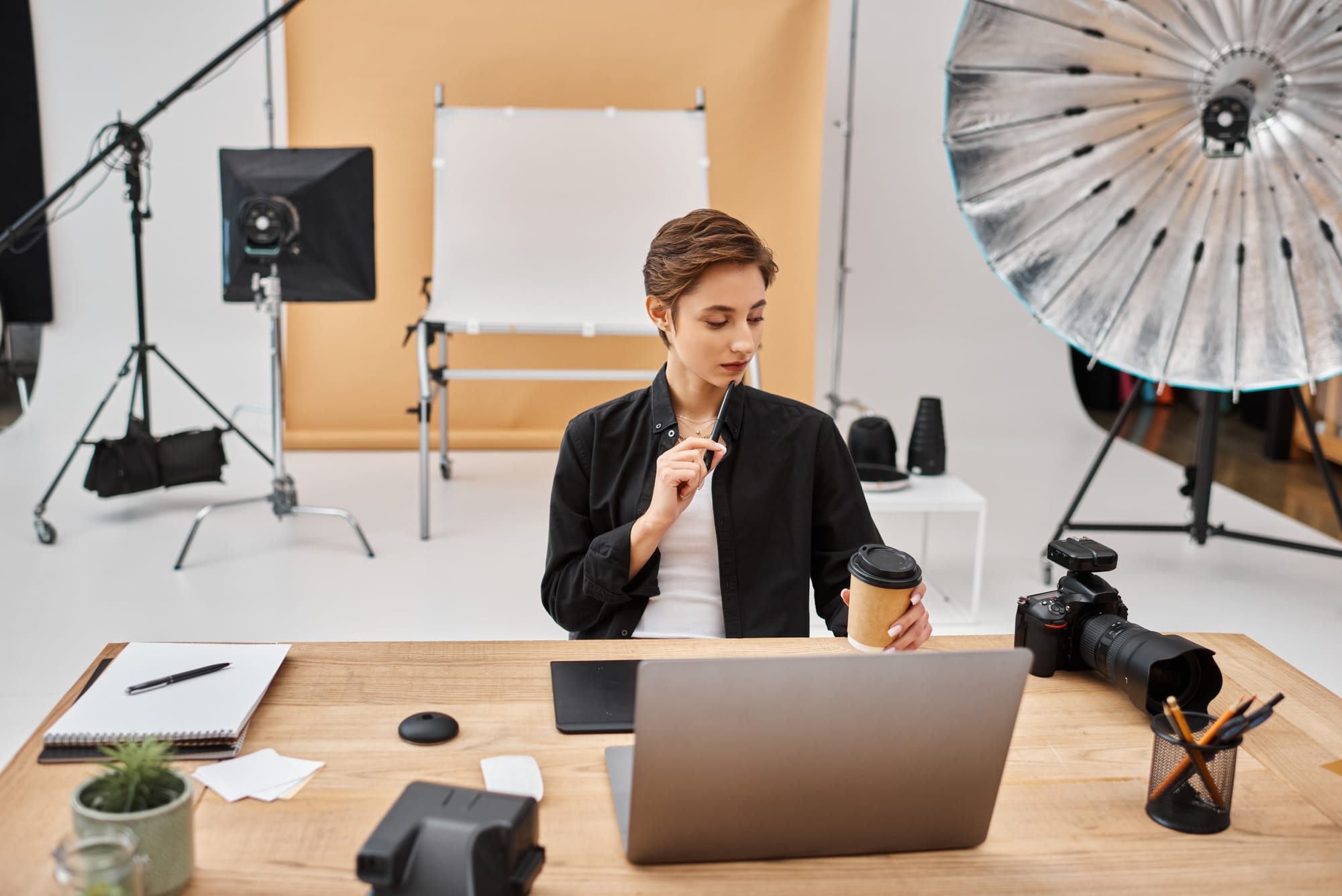 Female photographer working with laptop and camera