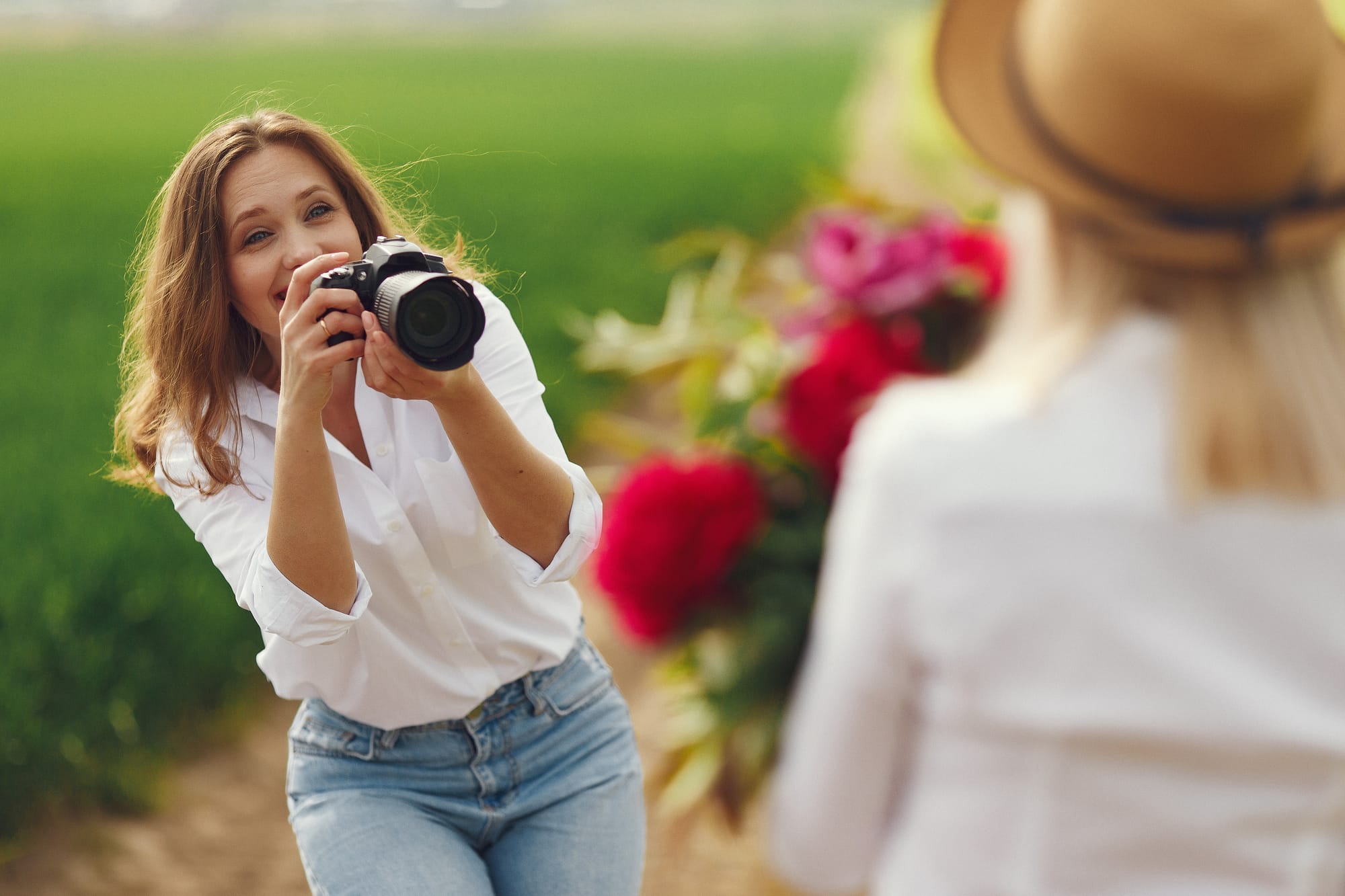 A professional photographer enjoying an outdoor photoshoot with a client