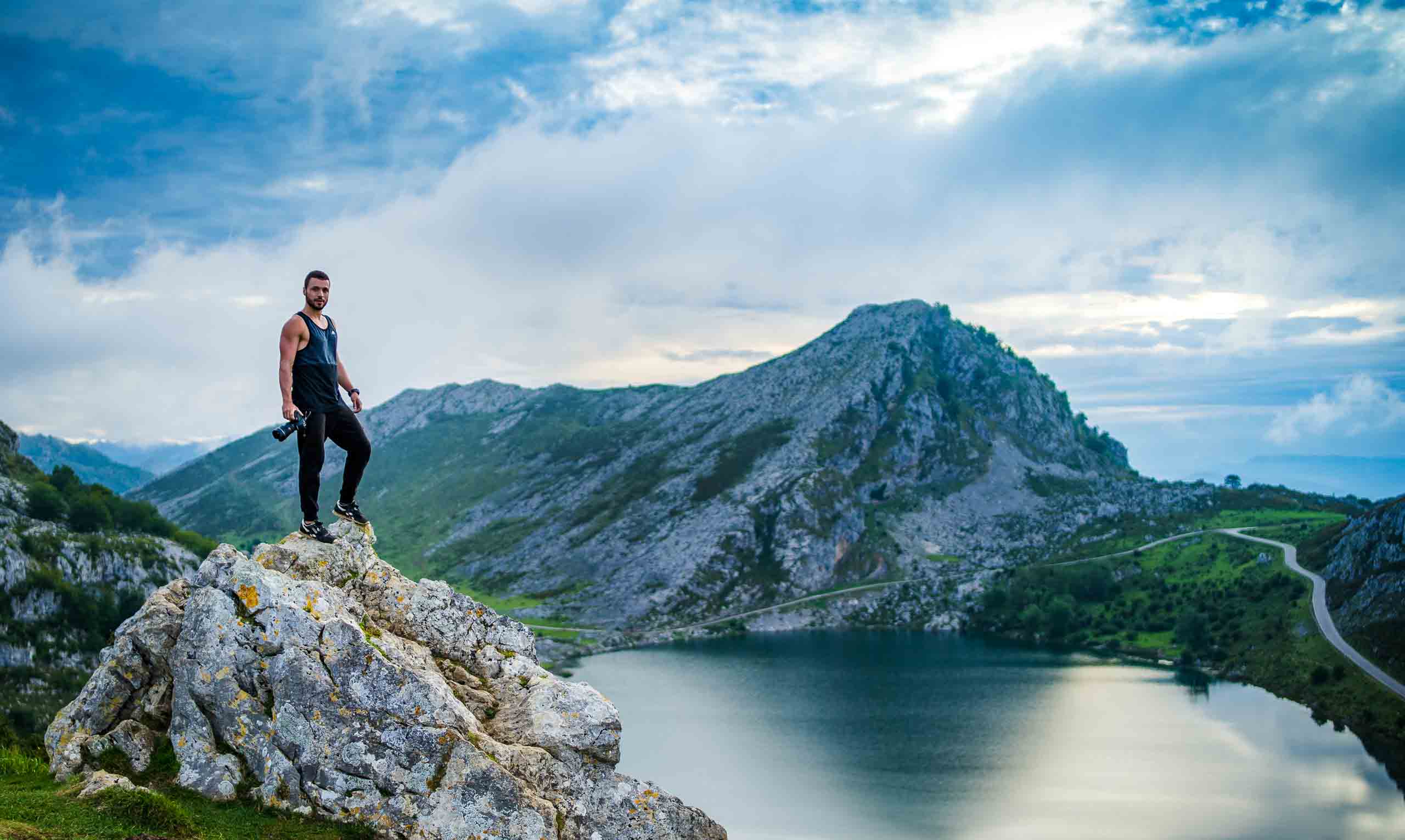 Photographer standing at the top of a mountain