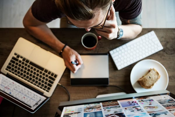 Professional photographer sitting in front of his computer