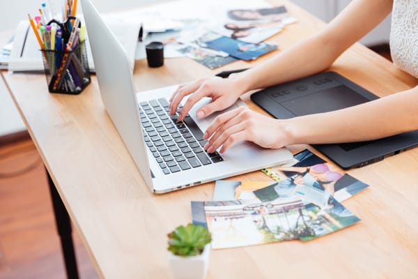 Photographer typing on her laptop